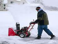 clearing snow with snow blower