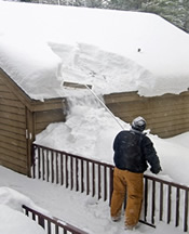 safely using a roof rake to clear snow